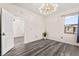Bedroom featuring hard wood floors, modern lighting and a large window at 2407 Ridgeline Wash St, Las Vegas, NV 89138