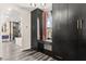 Modern closet featuring dark wood cabinetry, a built-in desk, and a window with curtains at 2407 Ridgeline Wash St, Las Vegas, NV 89138
