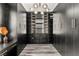 Spacious walk-in closet with custom built-ins, drawers, shelving and stylish modern lighting at 2407 Ridgeline Wash St, Las Vegas, NV 89138