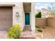 Inviting home entrance with a brick path, desert landscaping, and a pop of color from the front door at 2407 Ridgeline Wash St, Las Vegas, NV 89138