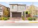 Contemporary home featuring a two-car garage, brick driveway, and mountain views behind it at 2407 Ridgeline Wash St, Las Vegas, NV 89138