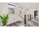 Well-lit hallway with modern railing and bright windows at 2407 Ridgeline Wash St, Las Vegas, NV 89138
