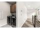 Laundry area with modern washer and dryer, complemented by hallway featuring modern railing at 2407 Ridgeline Wash St, Las Vegas, NV 89138