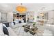 Bright, open-concept living room with modern decor and a stunning chandelier that enhances the space at 2407 Ridgeline Wash St, Las Vegas, NV 89138