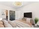 Staged main bedroom featuring modern furniture, television, and sleek design elements at 2407 Ridgeline Wash St, Las Vegas, NV 89138