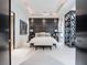 Sophisticated bedroom with a paneled accent wall, recessed lighting, and elegant furnishings for a stylish sanctuary at 28 Painted Feather Way, Las Vegas, NV 89135