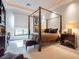 Comfortable bedroom featuring a four-poster bed, ample natural light, and neutral decor for a serene retreat at 28 Painted Feather Way, Las Vegas, NV 89135