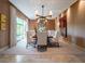Formal dining room featuring a grand table, chandelier, and modern wall art at 28 Painted Feather Way, Las Vegas, NV 89135