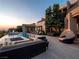 Luxury home exterior featuring a pool, lounge areas, and beautiful architectural design at 28 Painted Feather Way, Las Vegas, NV 89135