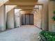 Stunning front entrance featuring travertine, a gated door, and vibrant floral accents at 28 Painted Feather Way, Las Vegas, NV 89135