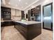 Contemporary kitchen showcases dark cabinets, stainless steel appliances, and a large center island at 28 Painted Feather Way, Las Vegas, NV 89135