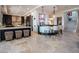 Modern kitchen with island seating and adjacent bar area, illuminated by stylish pendant lighting at 28 Painted Feather Way, Las Vegas, NV 89135