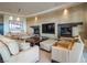 Elegant living room featuring dual fireplaces, neutral tones, and comfortable seating arrangements at 28 Painted Feather Way, Las Vegas, NV 89135