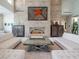 Sophisticated living room boasting a floor-to-ceiling stone fireplace and stylish furnishings at 28 Painted Feather Way, Las Vegas, NV 89135