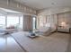 Spacious main bedroom featuring a canopy bed, sitting area, and panoramic windows with scenic views at 28 Painted Feather Way, Las Vegas, NV 89135