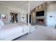 Spacious main bedroom featuring a fireplace, sitting area, and modern artistic decor for a relaxing ambiance at 28 Painted Feather Way, Las Vegas, NV 89135