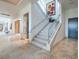 Elegant staircase featuring a glass railing, modern lighting, and sleek design for a stylish entryway at 28 Painted Feather Way, Las Vegas, NV 89135