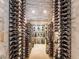 Climate-controlled wine cellar featuring extensive bottle storage and elegant marble accents at 28 Painted Feather Way, Las Vegas, NV 89135