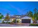 Charming stucco home with a tile roof, two-car garage, manicured landscaping, and beautiful curb appeal at 3020 Via Venezia, Henderson, NV 89052