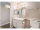 Well-lit bathroom with white vanity, mirror, and toilet at 3151 Soaring Gulls Dr # 2034, Las Vegas, NV 89128