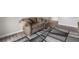Cozy living room features an accent rug, wood-look flooring, and a taupe sofa at 3151 Soaring Gulls Dr # 2034, Las Vegas, NV 89128