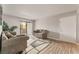 Open-concept living room features gray walls, wood-look flooring and a sliding glass door at 3151 Soaring Gulls Dr # 2034, Las Vegas, NV 89128