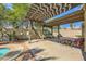 The cozy patio showcases a weathered pergola, offering a charming outdoor space with dappled sunlight at 3381 Biscayne Bay Dr, Las Vegas, NV 89117