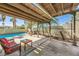 Inviting backyard features a covered patio, sparkling pool and spa, perfect for outdoor relaxation and entertaining at 3381 Biscayne Bay Dr, Las Vegas, NV 89117