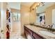 Bathroom with double sink vanity, granite countertop and tile flooring at 3381 Biscayne Bay Dr, Las Vegas, NV 89117