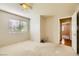 Bright bedroom with neutral carpet, ceiling fan, and plenty of natural light from the window at 3381 Biscayne Bay Dr, Las Vegas, NV 89117