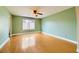 Empty bedroom with hardwood floors, a window, and neutral green paint at 3381 Biscayne Bay Dr, Las Vegas, NV 89117