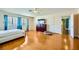 Spacious bedroom featuring hardwood floors, ceiling fan and natural light from a large window at 3381 Biscayne Bay Dr, Las Vegas, NV 89117