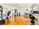 Bonus room with hardwood floors, bright natural light, a ceiling fan, and multiple furniture sets at 3381 Biscayne Bay Dr, Las Vegas, NV 89117