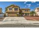 Two-story home featuring a two-car garage, well-manicured landscaping, and a charming exterior at 3381 Biscayne Bay Dr, Las Vegas, NV 89117
