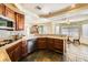 Well-equipped kitchen featuring dark stone countertops, dark cabinets, and modern appliances at 3381 Biscayne Bay Dr, Las Vegas, NV 89117