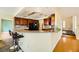 Open kitchen with dark wood cabinets, granite counters, breakfast bar, and slate flooring at 3381 Biscayne Bay Dr, Las Vegas, NV 89117
