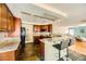 Open-concept kitchen with a breakfast bar, stone counters, and dark wood cabinets at 3381 Biscayne Bay Dr, Las Vegas, NV 89117