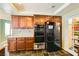 Functional kitchen offering dark wood cabinets and modern black appliances at 3381 Biscayne Bay Dr, Las Vegas, NV 89117