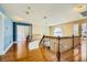Open landing with hardwood floors, wooden banister, and natural light at 3381 Biscayne Bay Dr, Las Vegas, NV 89117