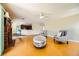 Inviting living room featuring wood floors, a fireplace, and an open design connecting to the kitchen at 3381 Biscayne Bay Dr, Las Vegas, NV 89117