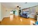 Bright and airy living room featuring hardwood floors, a ceiling fan, and a comfortable seating area at 3381 Biscayne Bay Dr, Las Vegas, NV 89117