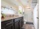 Bathroom featuring granite countertops, sleek cabinetry, and glass-enclosed shower at 3553 Judson Ave, Las Vegas, NV 89115