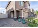 Home exterior featuring a charming entrance with potted plants, brick accents, and a two-car garage at 3553 Judson Ave, Las Vegas, NV 89115