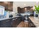Well-equipped kitchen features dark cabinetry, stainless steel appliances, and laminate wood flooring at 3553 Judson Ave, Las Vegas, NV 89115