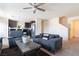 Inviting living room featuring neutral walls, plush carpeting, and an open layout to the kitchen and stairs at 3553 Judson Ave, Las Vegas, NV 89115