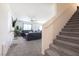 Inviting living room featuring plush carpeting, a ceiling fan, and stairs leading to the upper level at 3553 Judson Ave, Las Vegas, NV 89115