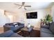 Inviting living room features comfortable seating, modern ceiling fan, and large screen television at 3553 Judson Ave, Las Vegas, NV 89115