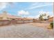 Large backyard featuring a paver patio and perimeter brick wall at 3606 Altar Rock Ln, North Las Vegas, NV 89032