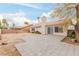 Spacious backyard featuring a brick perimeter fence, sizable patio, and desert landscaping at 3606 Altar Rock Ln, North Las Vegas, NV 89032