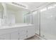 Bright bathroom featuring double sinks, vanity and a shower with sliding glass doors at 3606 Altar Rock Ln, North Las Vegas, NV 89032